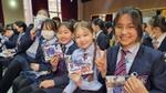 School girls in Mongolia smiling as they Pepsodent goody bag