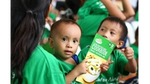 A child holds a Knorr Cook Book and seats on mother's lap