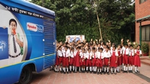 Group picture of school-going kids cheering and participating in a Pepsodant campaign.