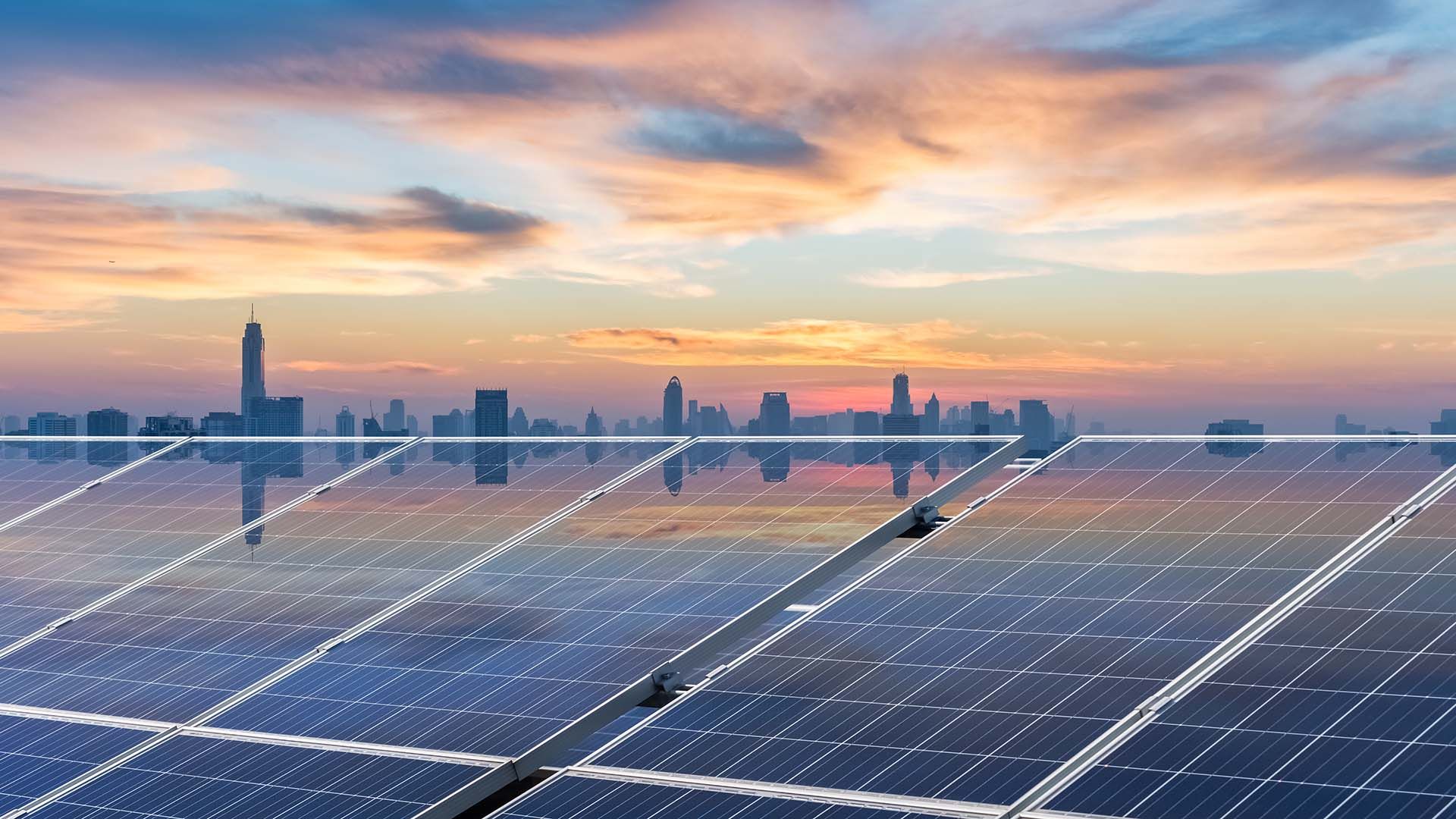 Solar panels with a city skyline background
