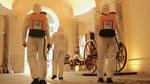 Three cleaners wearing protective clothing and carrying Lysoform spray backpacks in one of Italy’s main museums.