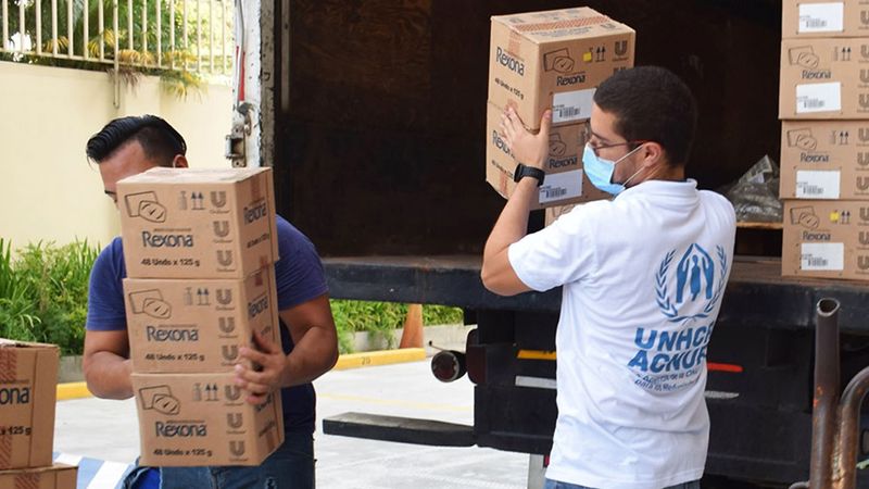 UNHCR workers removing boxes from a lorry