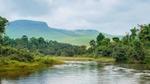 Congo river with mountains in the background and trees on the banks