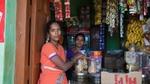 Two Shakti micro-entrepreneurs standing beside their small shop in India