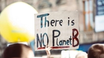 Image shows a sign saying ‘There Is No Planet B’