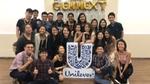 A group of smiling GEN-NEXT interns pose for the camera around a Unilever logo