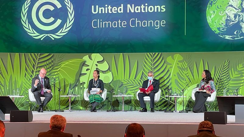 Unilever CEO Alan Jope sits far left on stage at the World Leaders Summit during COP26
