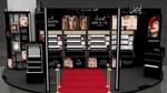 A House of Lakmé beauty counter in India featuring a red carpet and black lacquered furniture.