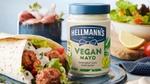Jar of Hellmann's Vegan Mayo beside a wrap containing vegan meatballs and salad.