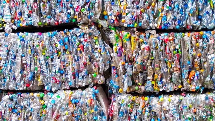 Plastic packaging flattened into six large bales