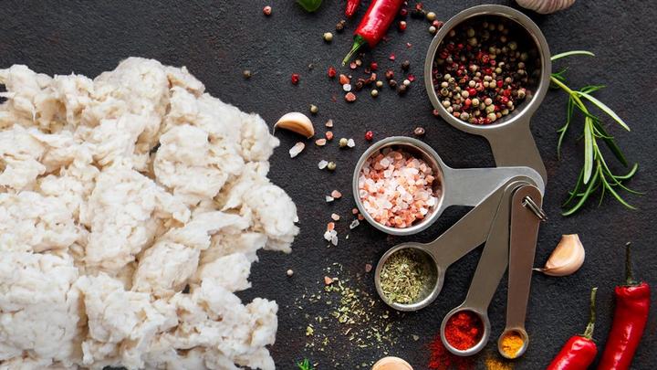 Fungi-based plant protein ABUNDA, developed by food tech firm ENOUGH, sitting on working surface with spices