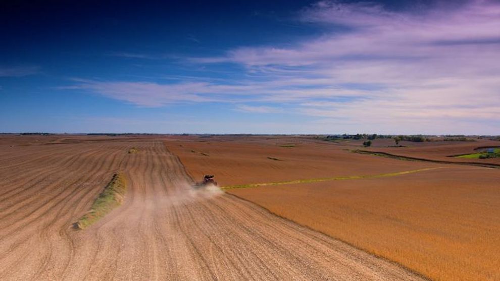 An aerial view of a combine harvester in the field