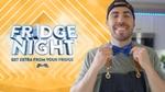 A man in an apron and bow tie smiling next to Fridge Night sign