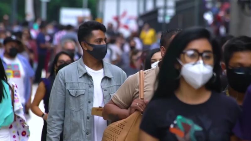 Man in a crowd wearing a mask