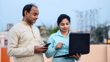 Young woman in India teaches man internet skills