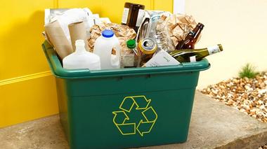 Green recycling box with rubbish inside