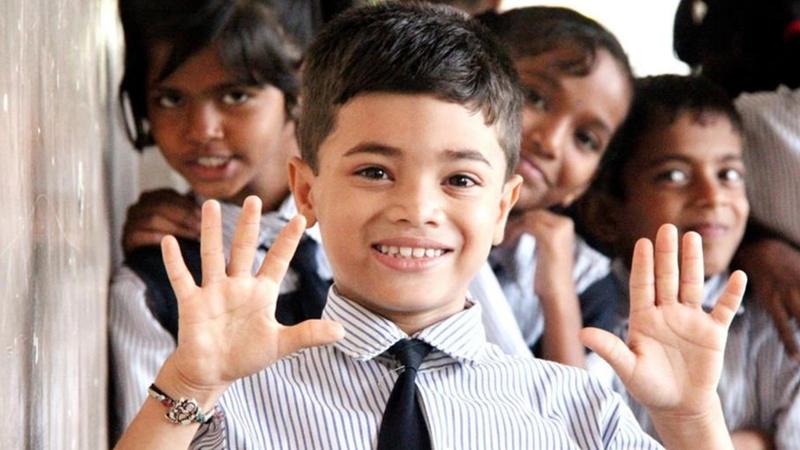Image of a school boy advocating handwashing 