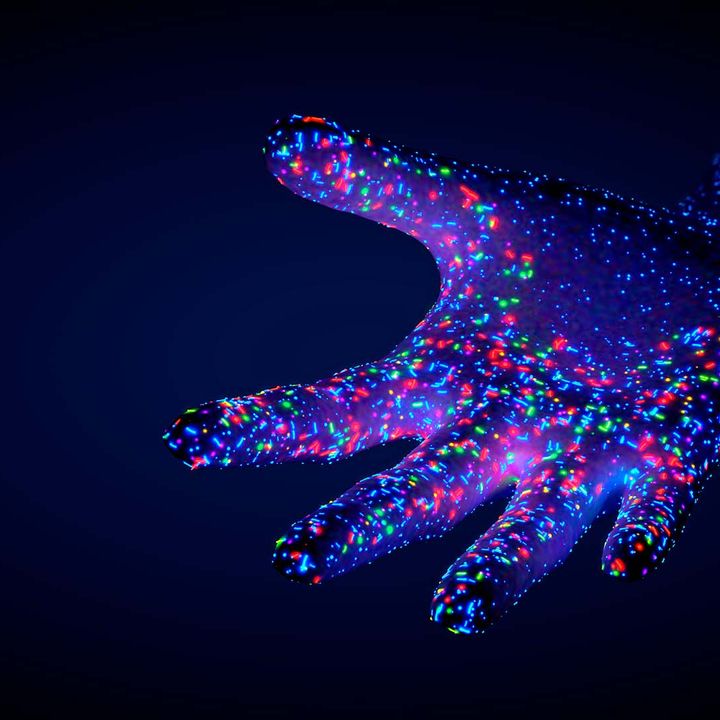 A hand reaches out on a dark blue background. It is covered in small coloured lights