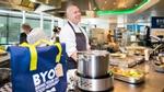 Chef in a kitchen with a Hellmann’s ‘Bring Your Own Food’ restaurant bag