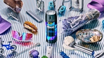 A can of Axe Blue Lavender body spray from the brand’s Fine Fragrance collection, surrounded by miscellaneous items.