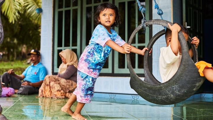 Children playing on a swing