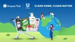 A cart of Unilever Home Care products beside a group of people cleaning up an image of the world