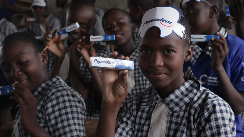 Kenyan kids holding toothpaste