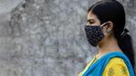 Side Face of an Indian woman wearing homemade cotton nose mask to reduce the spread of Covid-19 – stock photo