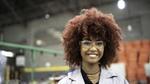 Young woman in lab coat and goggles. Unilever is committed to upskilling young people for ‘future fit’ job opportunities
