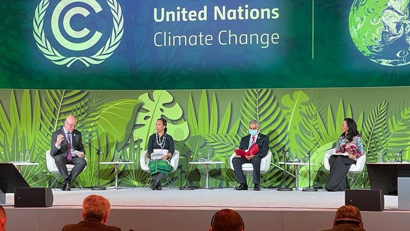 Alan Jope sits far left on stage at the World Leaders Summit during COP26, the climate change summit in Glasgow