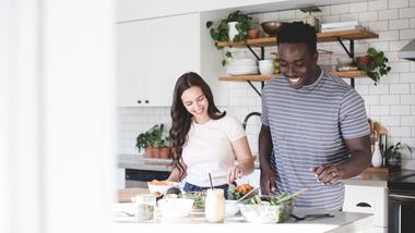 Young couple preparing food together in a kitchen