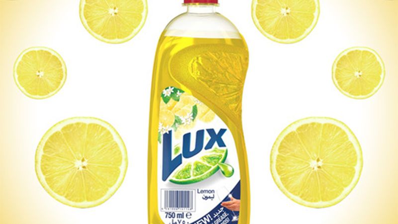 Advert showing a bottle of Lux hand dishwash with a background pattern of slices of lemon.