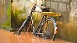 Photo of bike leaning against wall in brown water