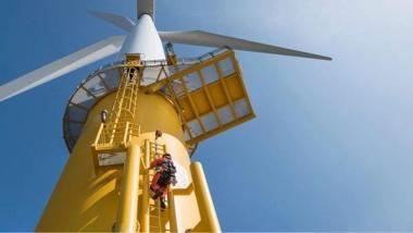 Man climbing up a ladder on a wind turbine