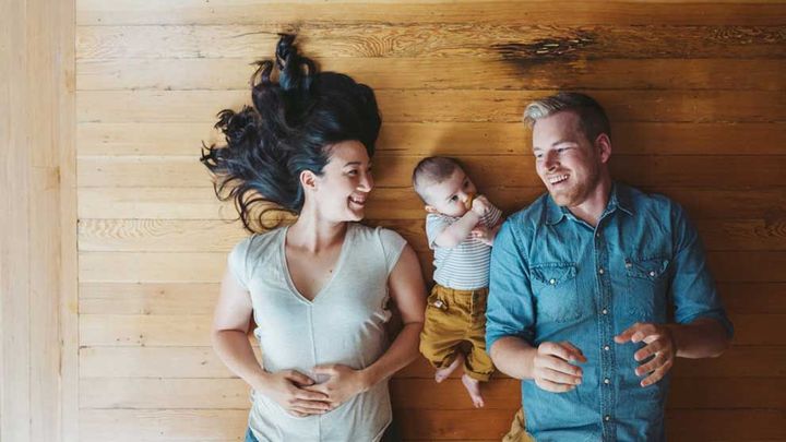 Family lying on the ground, smiling