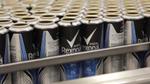 Empty Rexona deodorant bottles lines up in a factory