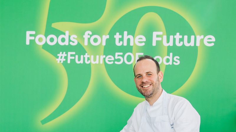 Michelin-starred chef Gregory Marchand sits in front of a green banner featuring the text Future 50 Foods