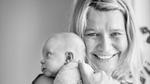 Katja Freiwald smiling & holding her baby