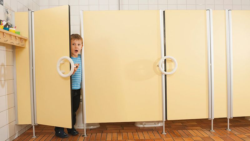 Boy looking out of cubicle