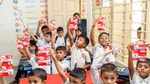 School children holding up Lifebuoy handwash sachets as part of a rural school activation programme.