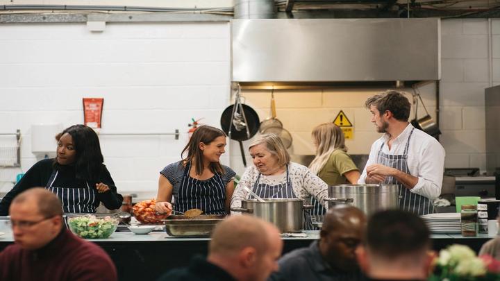 Five volunteers at a Knorr soup kitchen prepare food for healthy meals