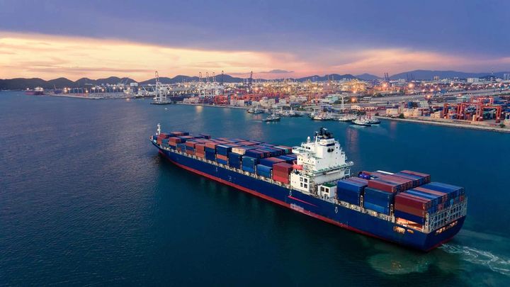 A cargo ship passing near a port