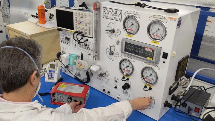 Image shows a scientist testing a ventilator at Smiths Medical.
