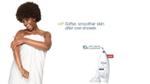 Woman in towel smiling in Dove shower advert