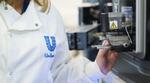 Unilever employee using scientific machinery. 