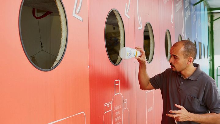 A man recycling at a bottle bank