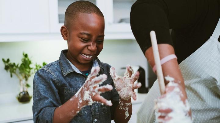 Boy cooking with sticky fingers. Family meal plans and activities were key F&R initiatives during lockdown.