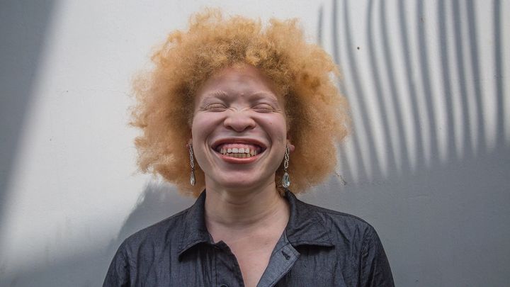 Picture of a person with a big smile and eyes closed