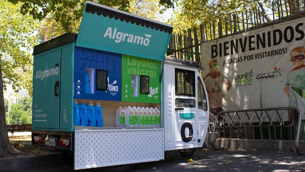 Quix and Omo bottles with an Algramo van in the background