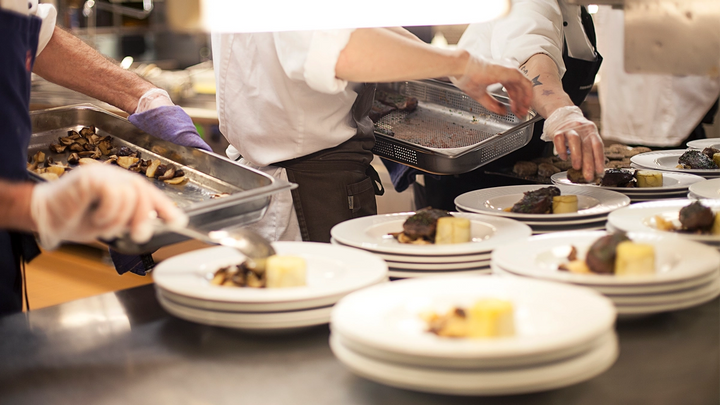 Plates of food being prepared in a kitchen